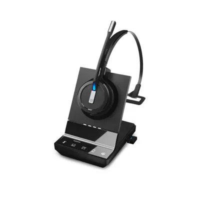 A black wireless headset with a microphone boom is resting on its charging base. The base has several touch-sensitive buttons and indicator lights.