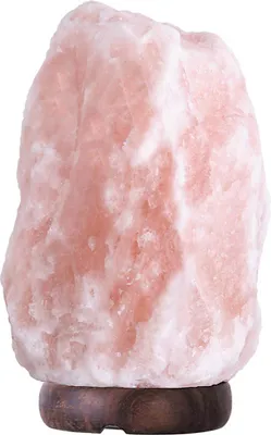 A pink Himalayan salt lamp on a wooden base.
