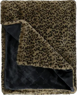A folded blanket with a leopard print on one side and a quilted black lining on the other.