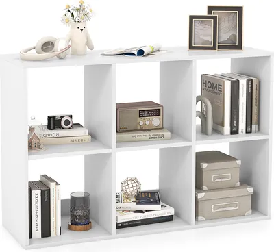 A white cube bookshelf filled with various decorative items and books.