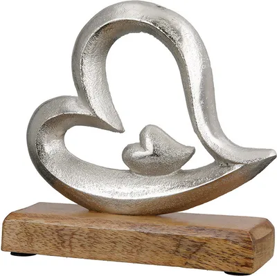 A silver heart sculpture with a smaller heart inside, mounted on a wooden base.