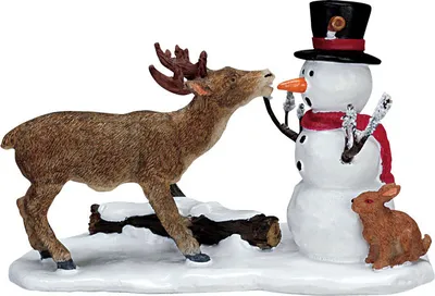 A ceramic figurine of a deer interacting with a snowman and a rabbit in a snowy setting.
