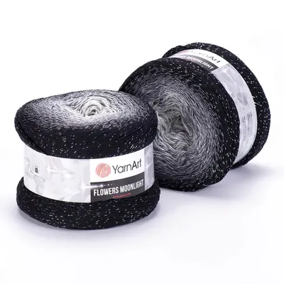 Two balls of yarn with an ombre color transition from black to white, with glittery accents.