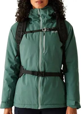 A woman wearing a green jacket and a backpack.