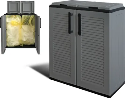 A gray, two-compartment outdoor storage cabinet for trash cans or recycling bins, shown with the doors open to reveal two yellow trash bags inside.
