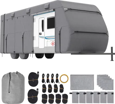 A grey caravan cover is shown on a white background, with various accessories laid out below.