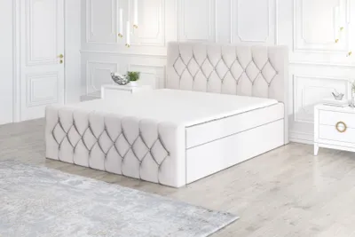 A bedroom scene with a large upholstered bed as the focal point.