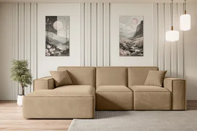 A modern living room with a beige sectional sofa, two pieces of abstract art on the wall, and pendant lights.