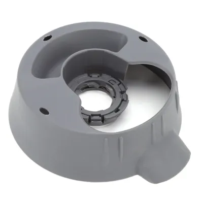 A gray plastic part of a kitchen appliance, likely a base or housing, with a dark gray internal component visible.