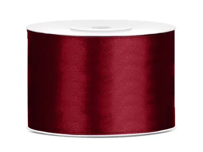 A roll of burgundy satin ribbon on a white spool, presented against a white background.