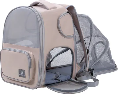 A beige and gray pet carrier backpack with mesh windows and an expandable side.