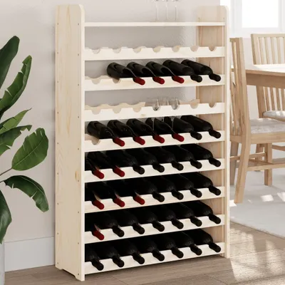 A tall wooden wine rack filled with wine bottles, placed indoors next to a large green plant.