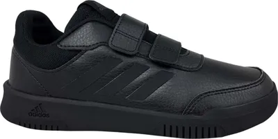 A black Adidas sneaker with velcro straps is shown against a white background.
