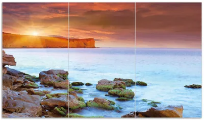 Produktbild von Wallario Herdabdeckplatte aus Glas, Größe 90 x 52 cm 3-teilig, Motiv Sonnenaufgang am Meer mit Landzunge und Felsen im Wasser