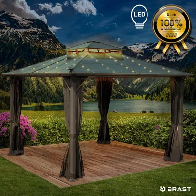 A gazebo with LED lights is set up in a scenic outdoor location with mountains and a lake in the background.