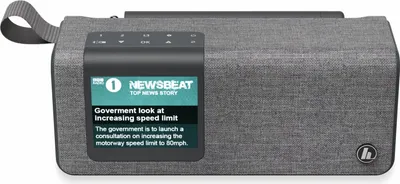 A gray digital radio with a screen displaying news headlines.