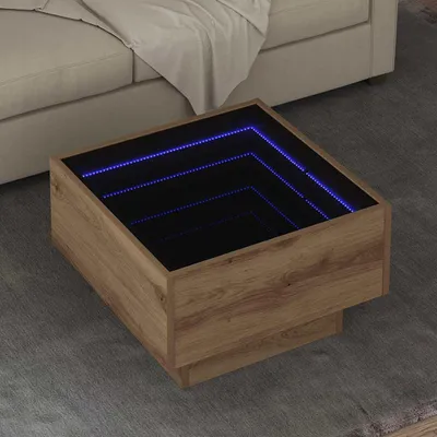 A square coffee table with an infinity mirror effect and blue LED lights is placed on a gray rug next to a beige sofa.