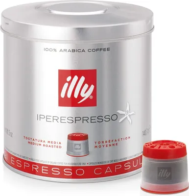 A cylindrical tin of Illy Iperespresso coffee capsules and one loose capsule.