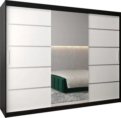 A modern bedroom with a large sliding door wardrobe with mirrored panels, reflecting a bed with a green headboard.