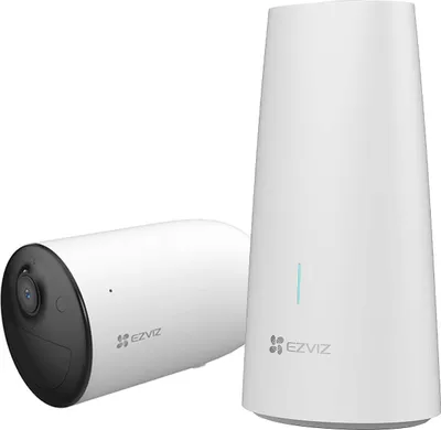 A white wireless security camera and its base station are shown against a white background.