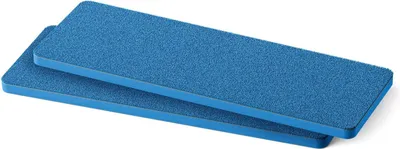 Two blue rectangular cleaning pads are stacked on a white background.