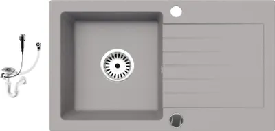 A top-down view of a gray granite kitchen sink with a drain and a separate siphon set.
