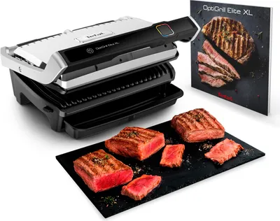 A Tefal OptiGrill Elite XL contact grill is shown with grilled steaks on a slate platter and a marketing brochure.