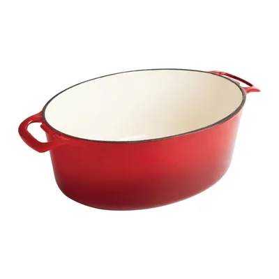 A red oval cast iron pot with a white interior, shown from a side-diagonal angle on a white background.