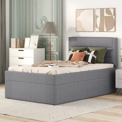 A bedroom scene with a bed, dresser, and lamp.