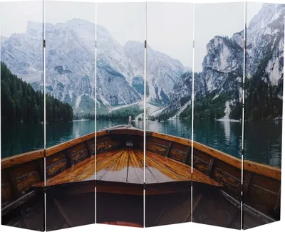View from inside a wooden boat looking out at a lake and mountains.