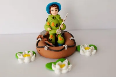 Produktbild von Kuchendekoration Fischer-Figur aus Zucker mit Boot und Seerosenblüten