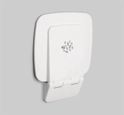 A white wall-mounted shower seat is shown against a plain gray background.
