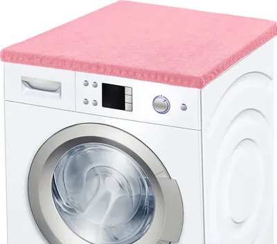 A pink terry cloth cover is placed on top of a white washing machine.
