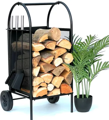 A black metal firewood rack filled with logs, with a potted plant to the right.
