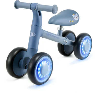 A blue balance bike with illuminated wheels is shown against a white background.