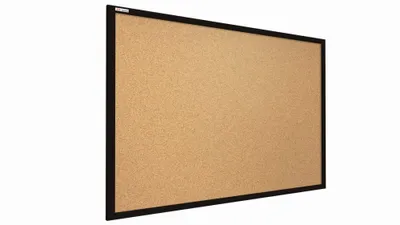 A cork bulletin board with a black frame, shown from a slight angle against a white background.