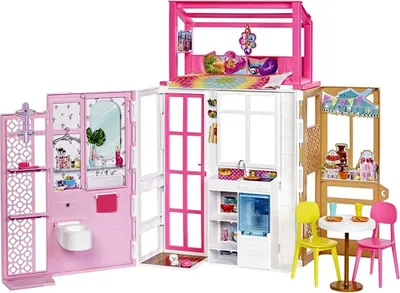 A Barbie dollhouse with multiple rooms and accessories.