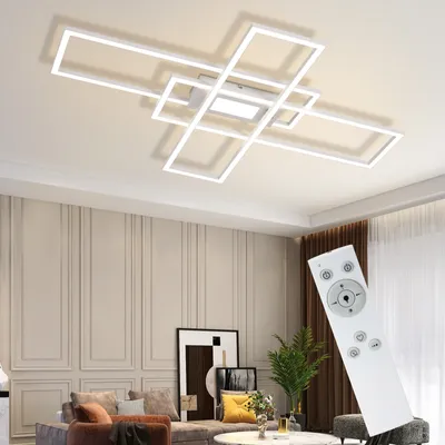 A modern living room with a geometric ceiling light and a remote control.
