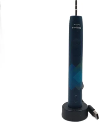 A dark blue electric toothbrush with a charging base and USB cable, set against a plain white background.