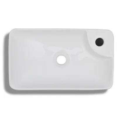 A top-down view of a white ceramic sink with a faucet hole and a drain hole.