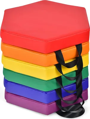A stack of colorful hexagonal floor cushions in rainbow colors.