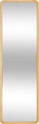 A full-length rectangular mirror with a light wood frame.