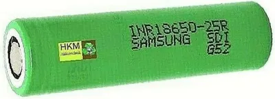 A single green cylindrical battery with text and a small logo on it, isolated on a white background.