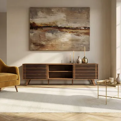 A living room scene featuring a TV lowboard, armchair, coffee table, and artwork.