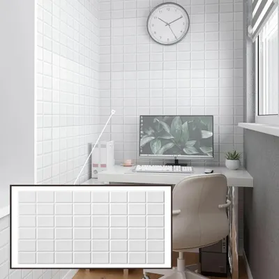 A corner of a room with white tiled walls, a desk with a computer, and a chair.