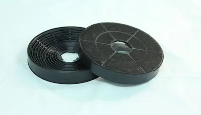 Two round charcoal filters for a kitchen hood.