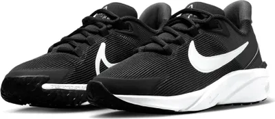 A pair of black Nike Star Runner 4 sneakers with white Nike swoosh logos and white soles, shown from a slightly elevated front-left angle against a white background.