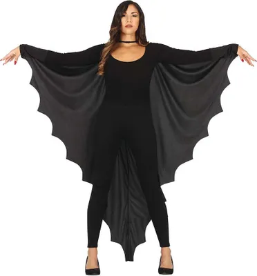 A woman is posing in a black costume with bat wings.