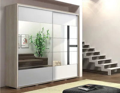 A modern bedroom or living room scene featuring a large wardrobe with mirrored doors, next to a staircase.