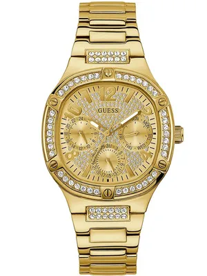 A close-up studio shot of a gold Guess watch with diamond-like embellishments on the bezel and dial.